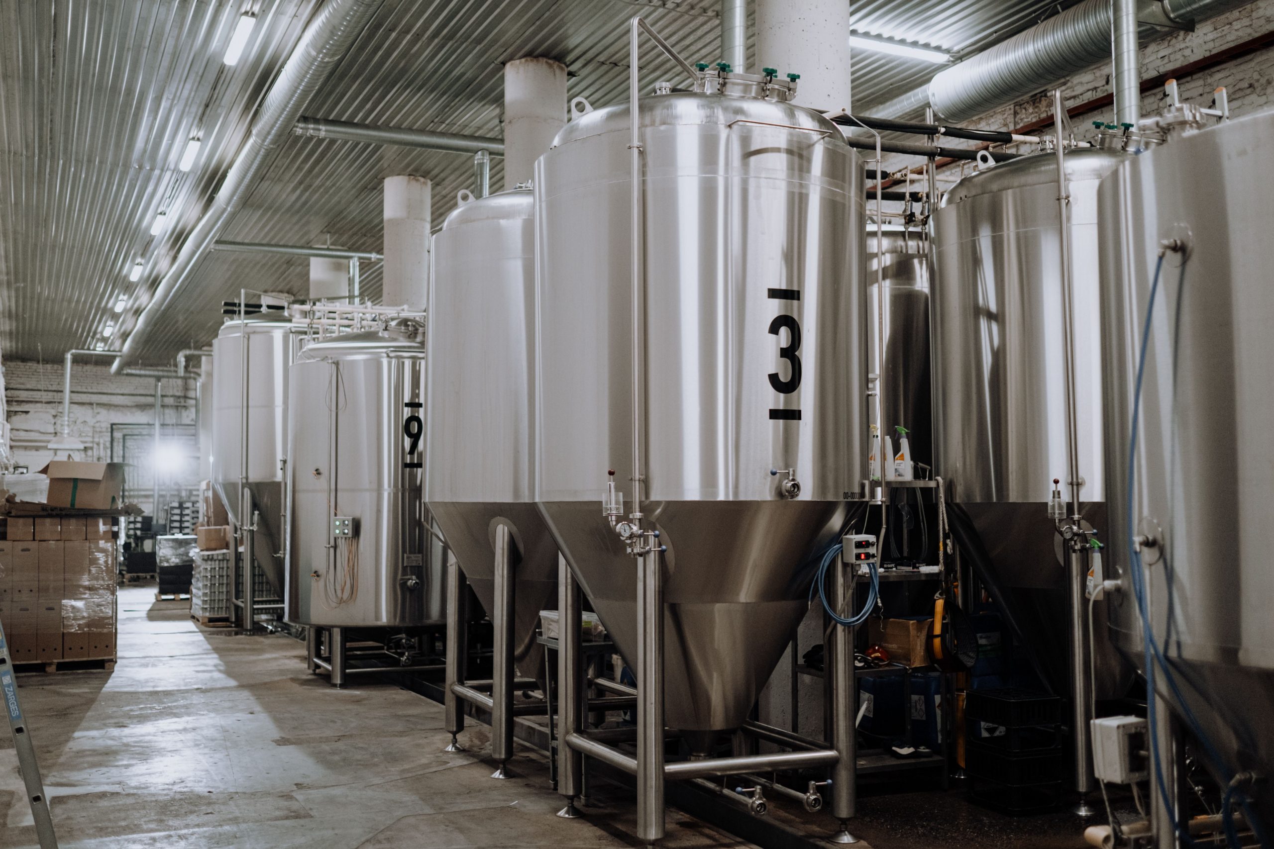 Modern brewery showcasing stainless steel fermentation tanks. (Food processing)